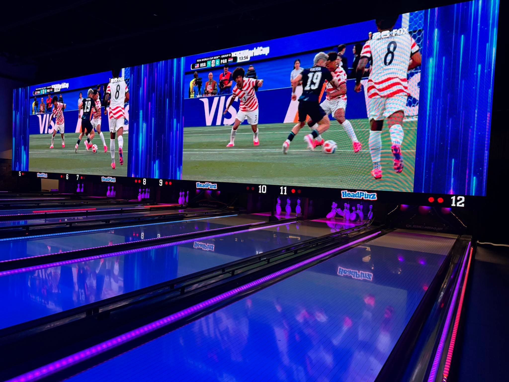 World Cup match on the NeoVerse LED wall over the VIP bowling lanes